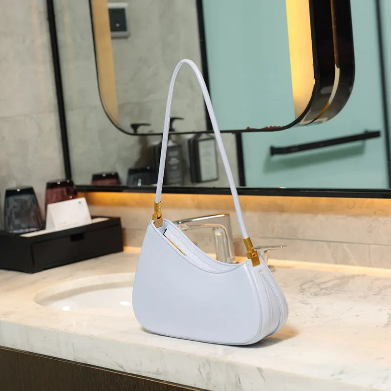 Retro oval women's underarm handbag in multiple colours, showing sandwich pocket design and single shoulder strap.