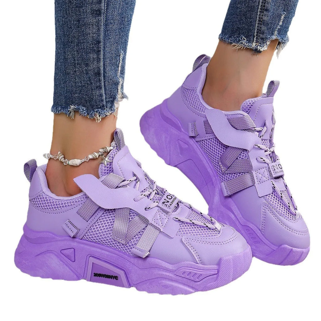 Women's purple platform mesh sports sneakers with animal pattern and lace-up front.