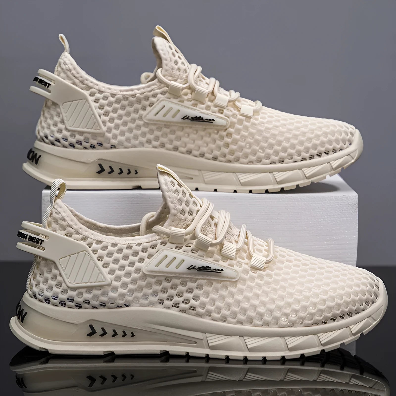 Men's beige casual sneaker with synthetic leather upper, mesh lining, and lace-up front.