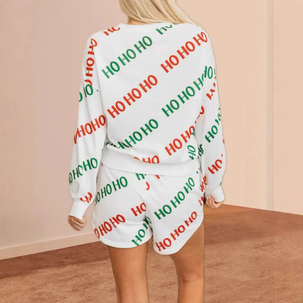 White women's two-piece suit with printed letters design, showing long-sleeved top and matching trousers
