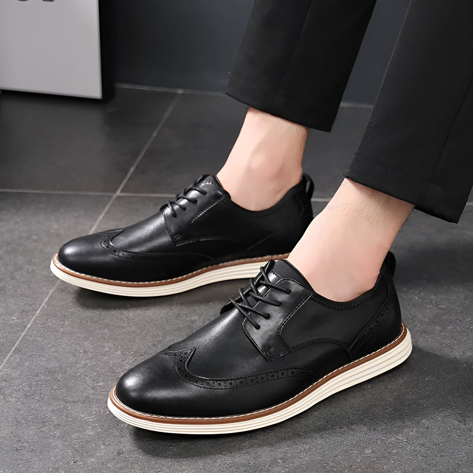 Men's black slip-on business casual shoes with round toe and decorative carving details