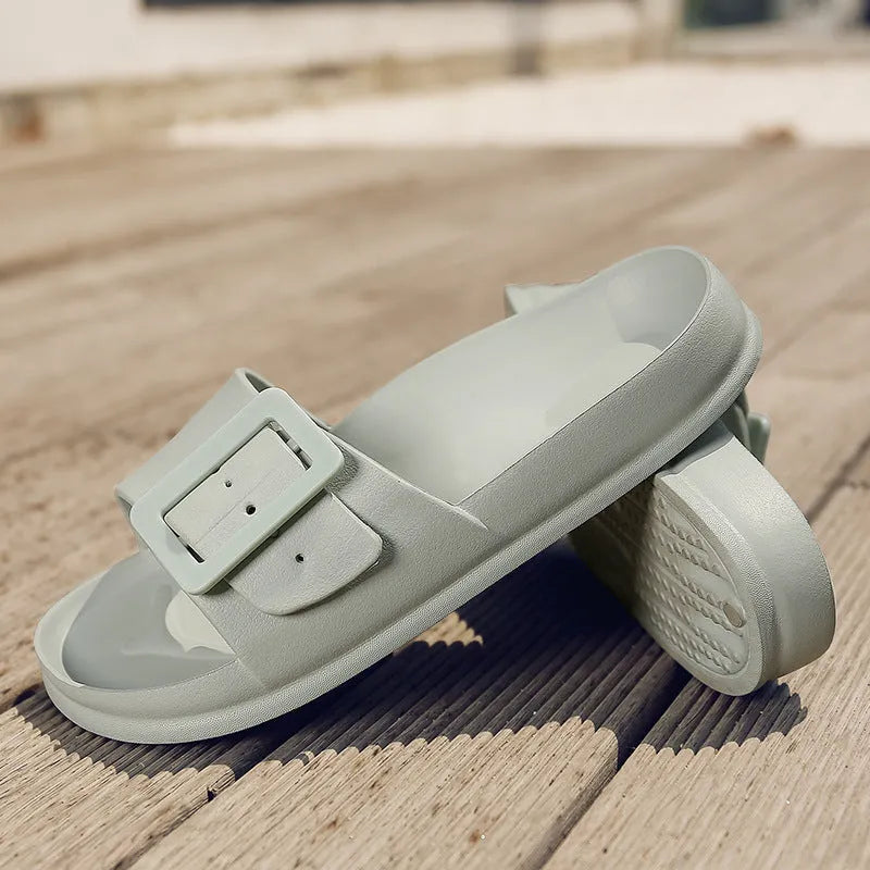 Women's grey blue flip-flop slippers with a buckle strap on a soft EVA sole.