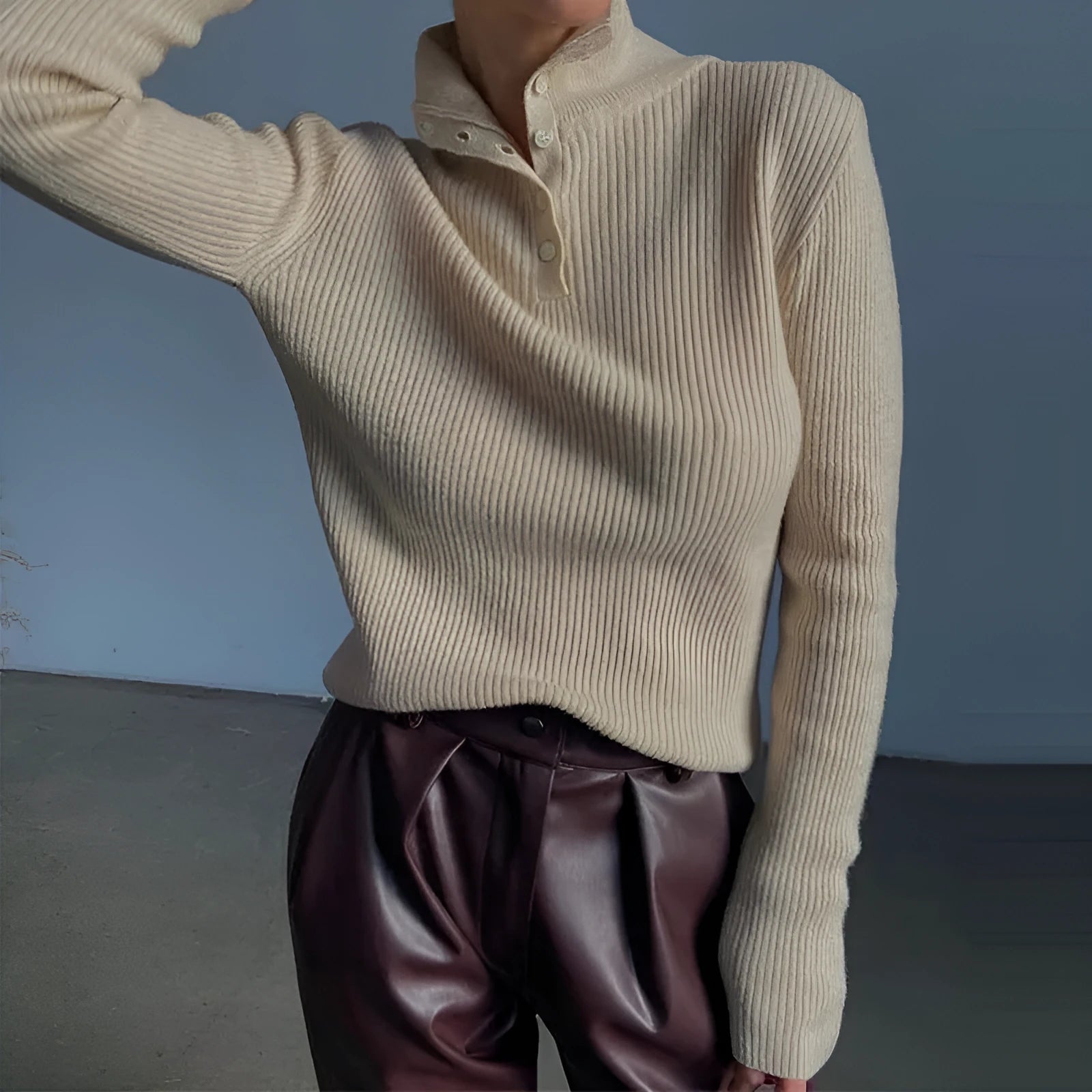 Women's silver grey slim fit pullover sweater with a half turtleneck and single-breasted placket on a hanger.