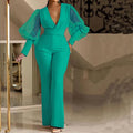 Red long sleeve women's jumpsuit with slim bodice, wide legs, and elasticated waist.