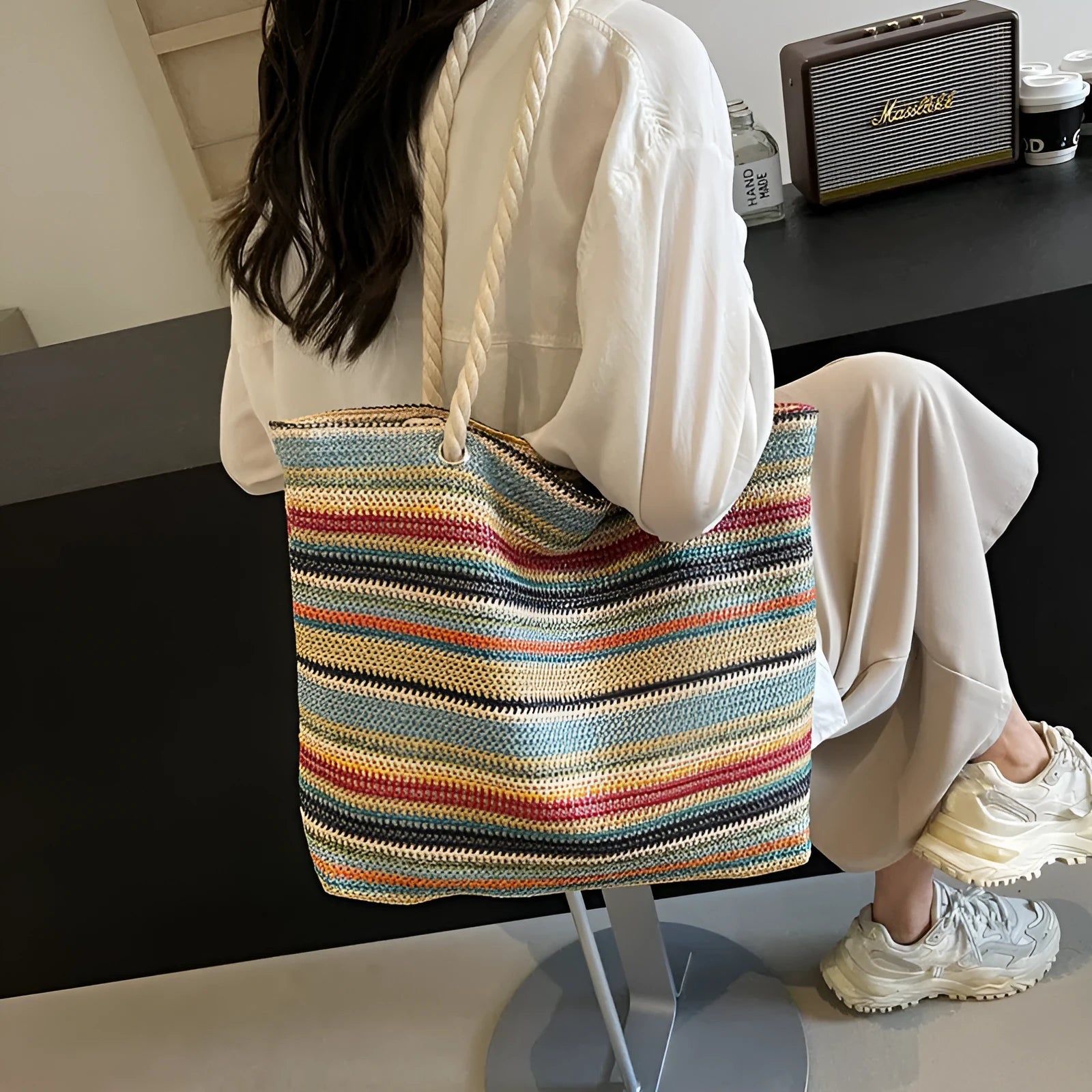 Blue straw-woven nylon shoulder bag with large main compartment and single strap