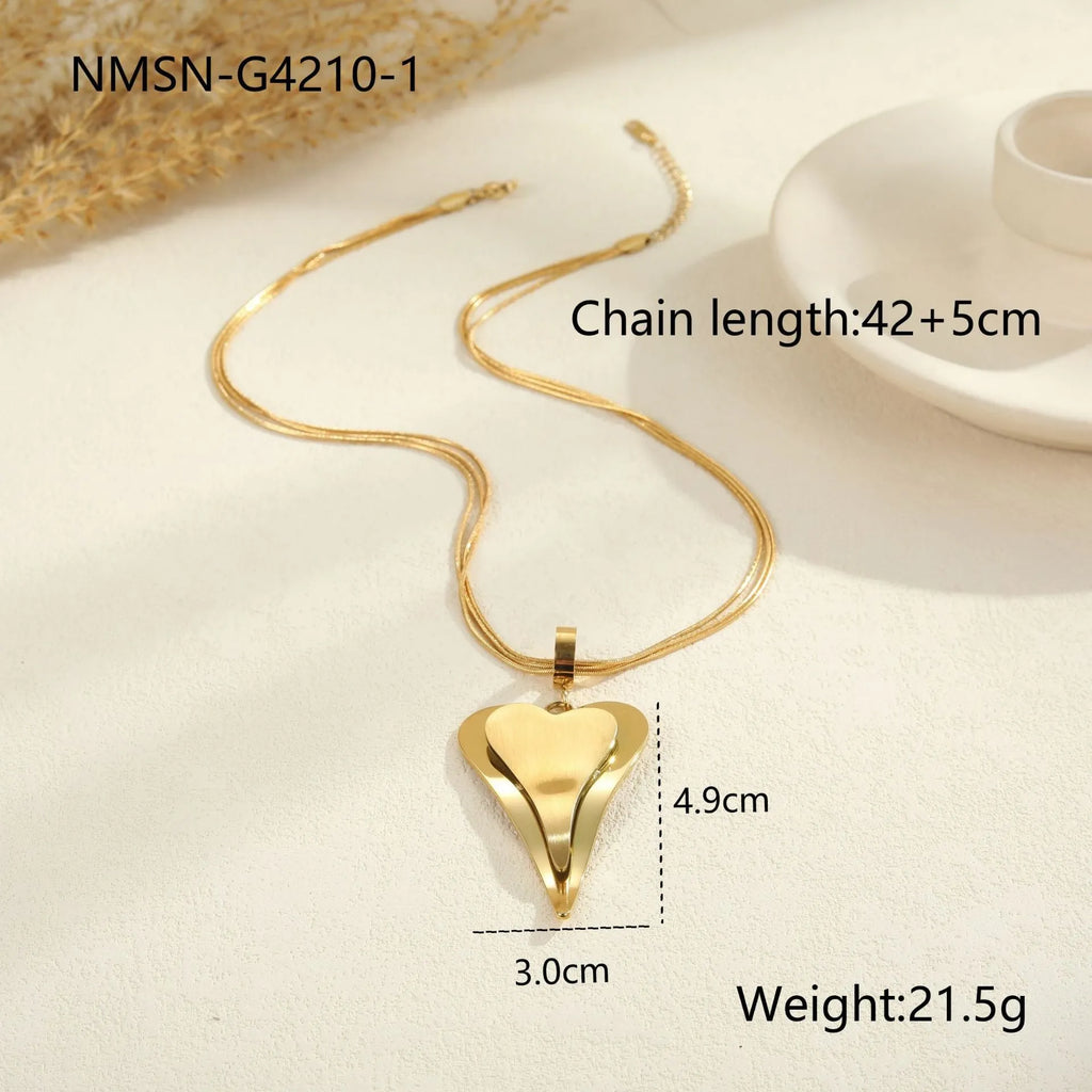 Double heart geometric pendant necklace with snake bones chain in stainless steel, shown in gold and steel colour options.