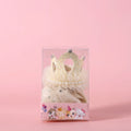 Cat wearing a princess crown headdress with a long, flowing veil in beige or pink colour.