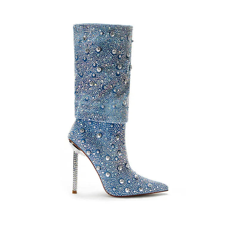 Women's blue denim pointed toe heel boots with stretchy fit on a plain background