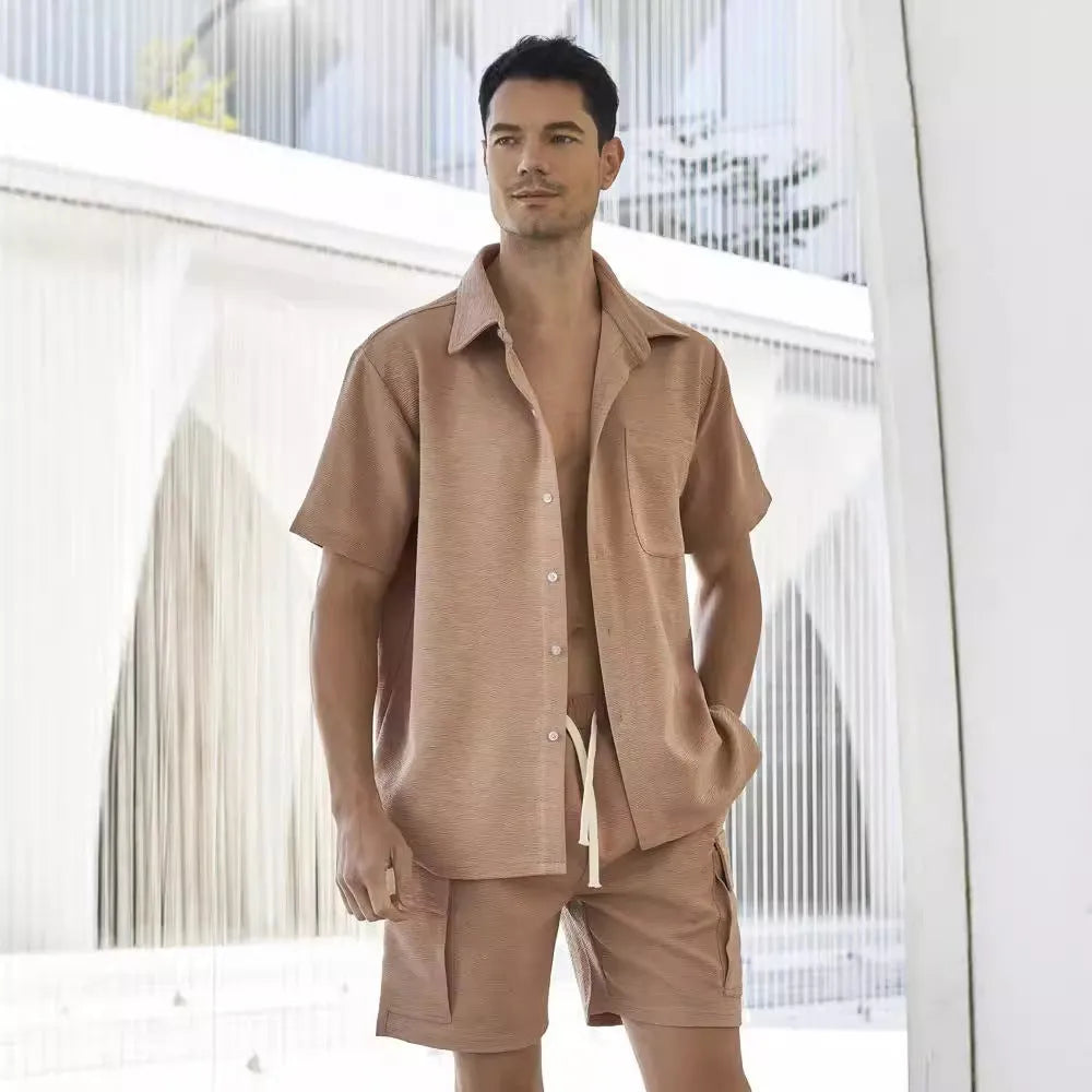 Women's beige polyester two-piece set with short sleeve top and elastic waist shorts laid flat.