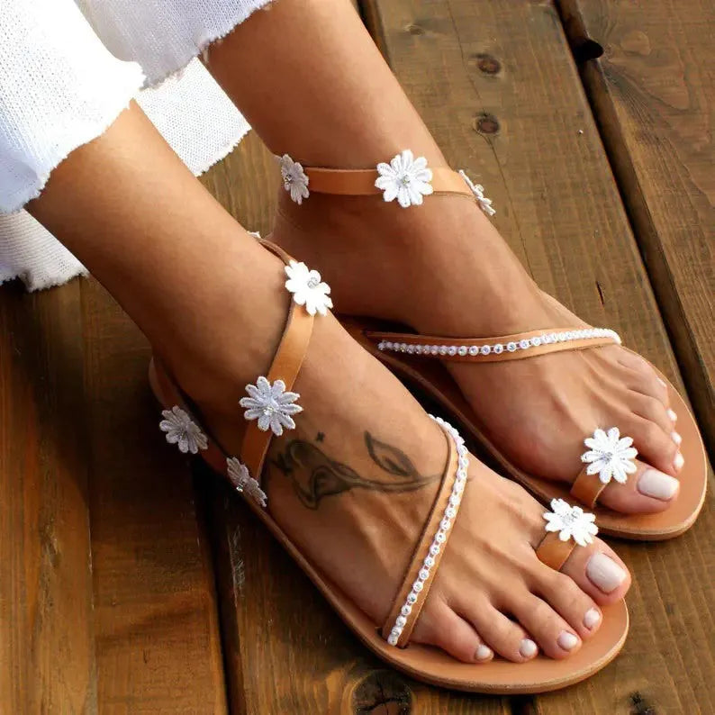 Brown ladies flat sole Roman sandals with floral pattern and elastic sleeves
