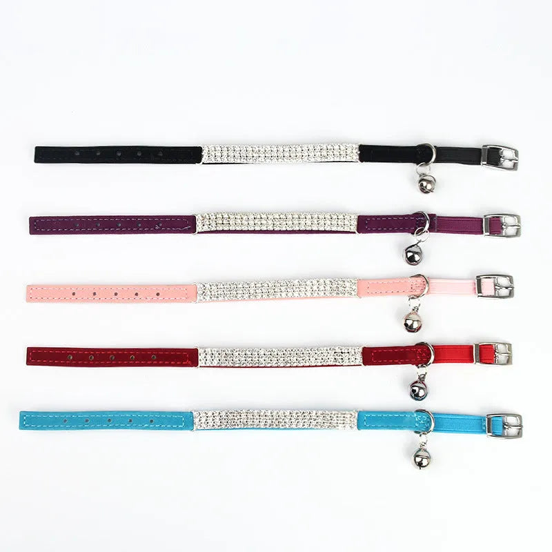 Velvet suede cat collar with rhinestone decoration in various colours on a white background.