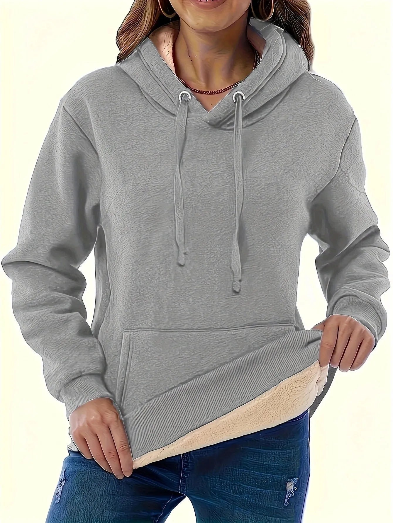 Women's loose grey hooded sweater with a 3D textured pattern on the front.