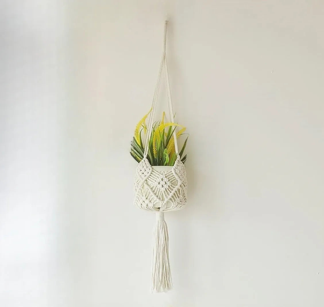 Handwoven brown polyester cotton flower pot net sleeve covering a plant pot.