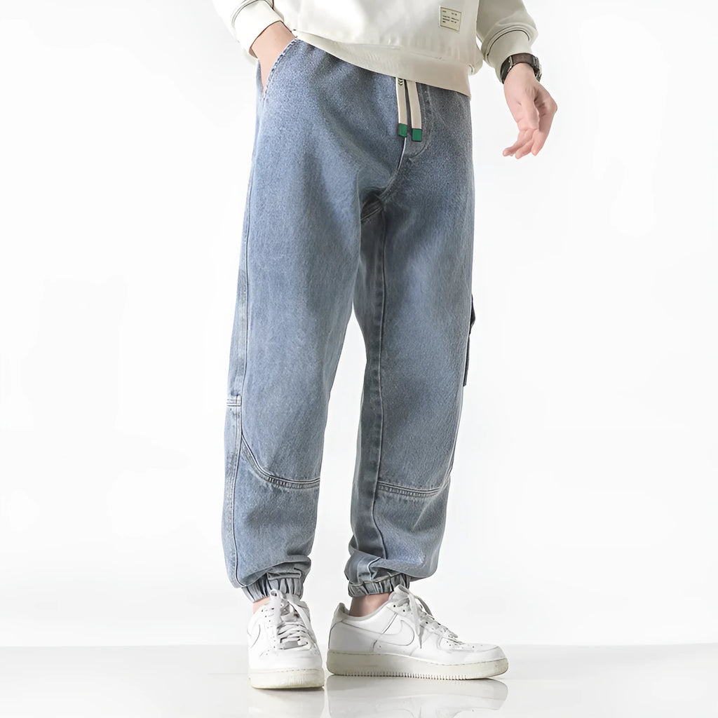 Men's loose-fit tapered cotton trousers in black colour showing mid-rise waist and tapered leg silhouette