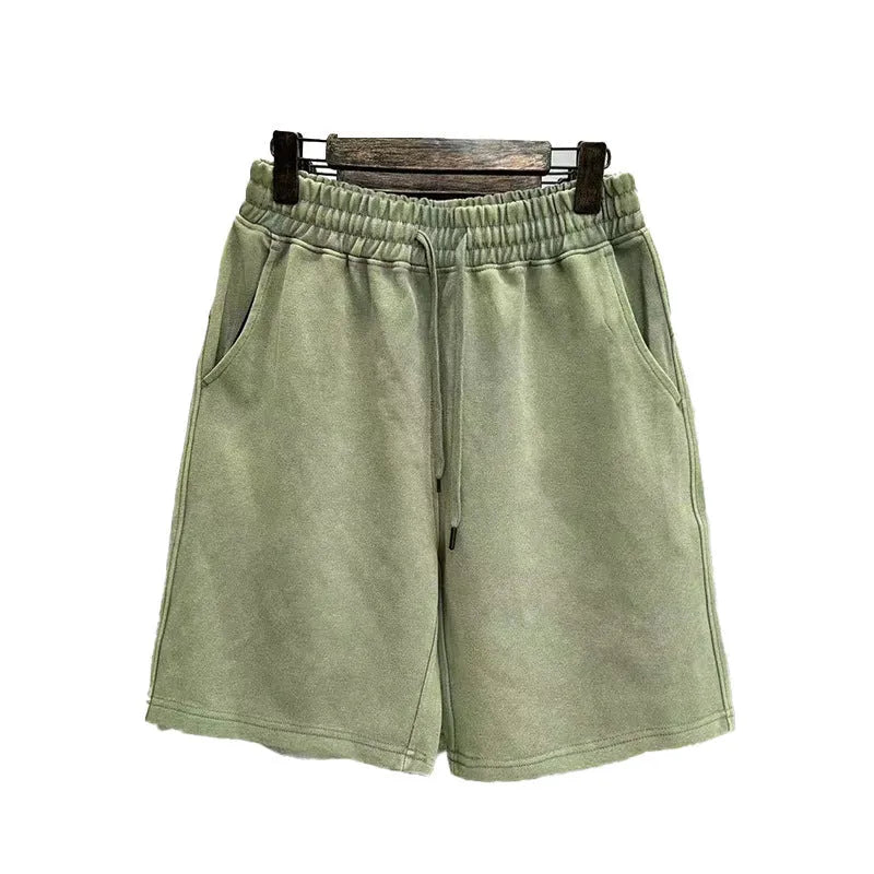 Men's charcoal black distressed denim shorts with straight leg and fifth pants length on a white background.