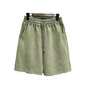 Men's charcoal black distressed denim shorts with straight leg and fifth pants length on a white background.