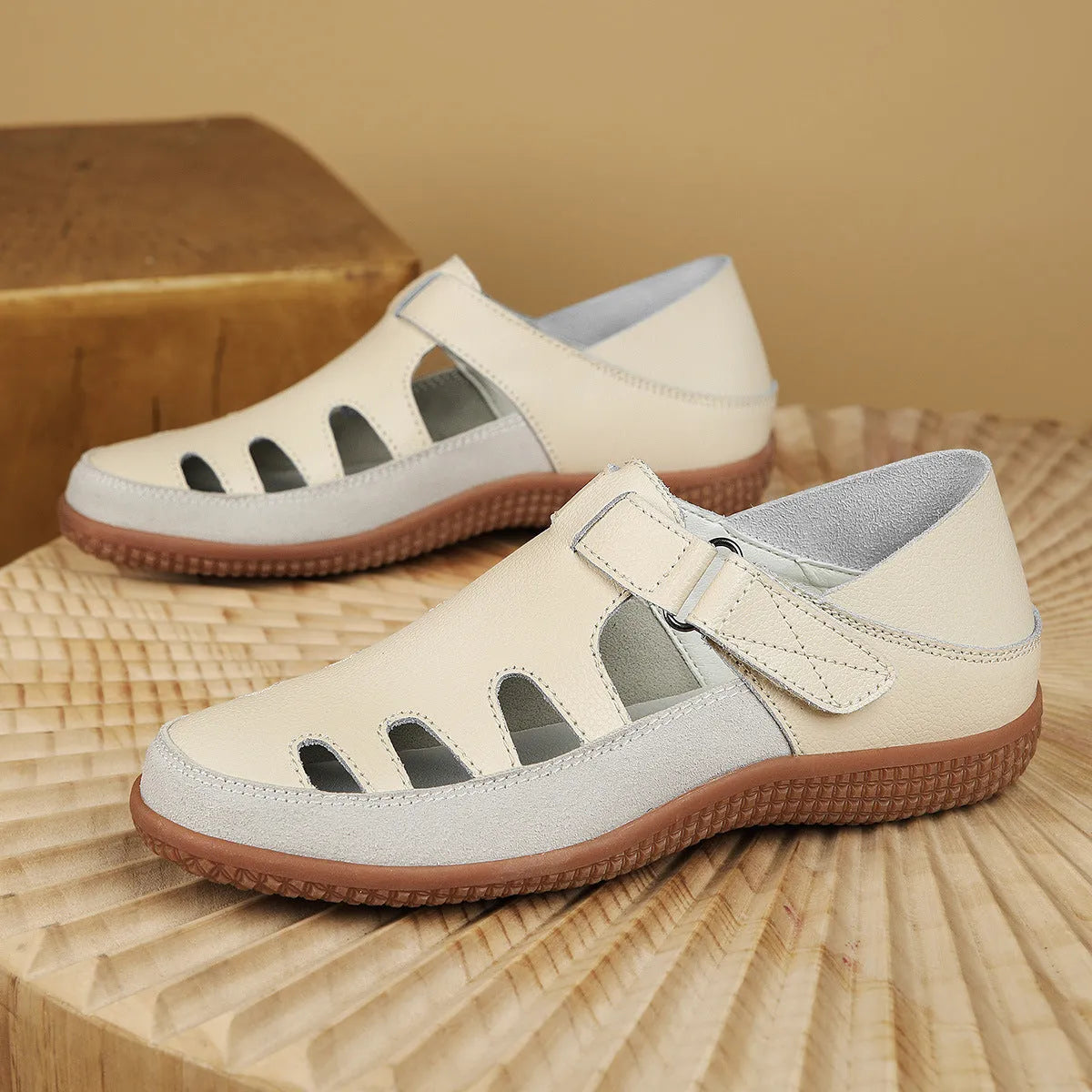 Women's plus size flat sandals with hollow-out toe cap in red, white, or blue on a thick rubber sole.