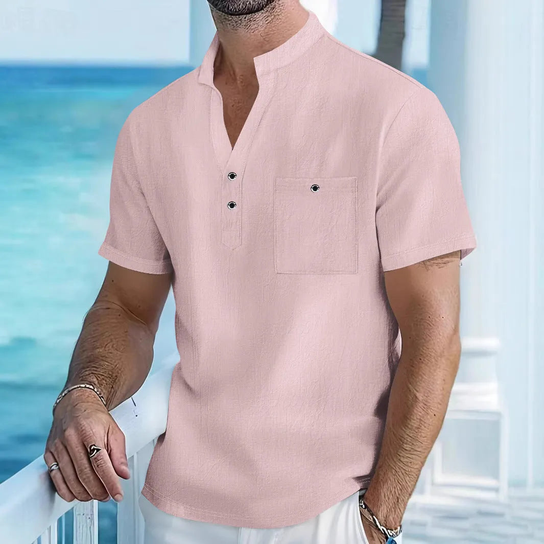 Man wearing a light blue linen-blend stand collar T-shirt with short sleeves and a loose fit.