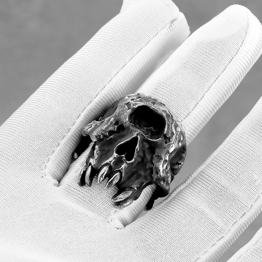 Alloy skull ring with one-eyed design in electroplated finish shown on finger