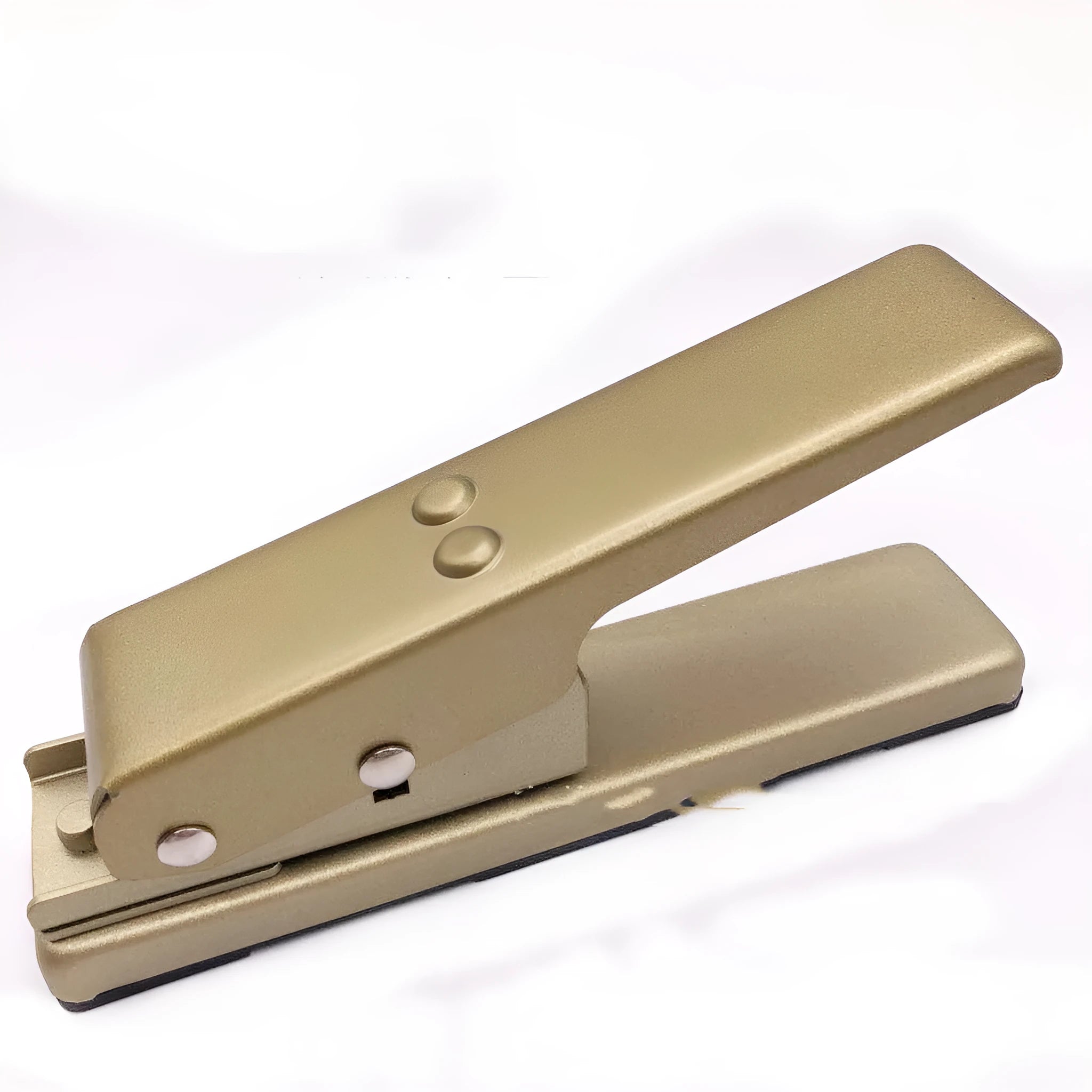 Gold metal guitar pick card cutter on a flat surface showing the punch head and metallic finish