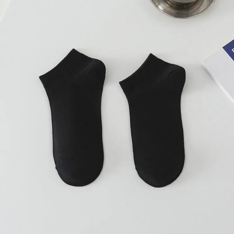 A pair of solid colour low-cut boat socks made from breathable polyester, shown in one of six available colour options.