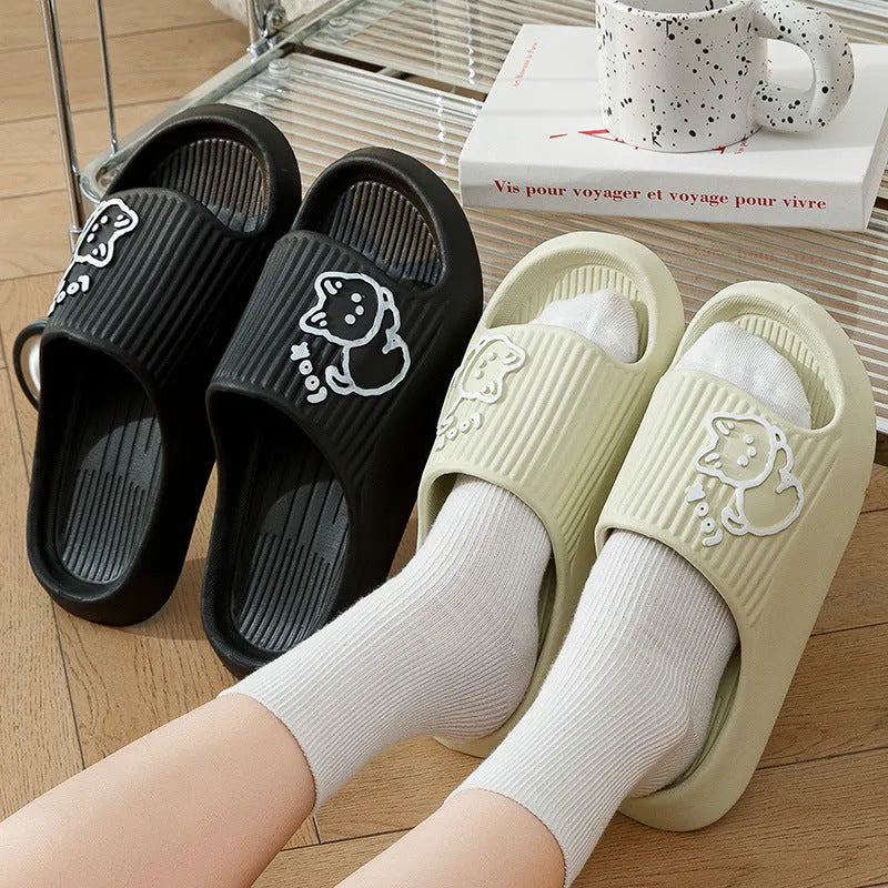 Green cat design thick EVA platform slippers on a wooden floor