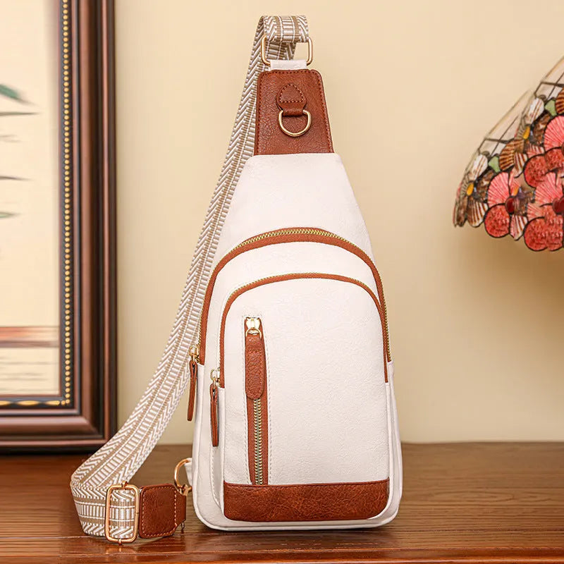 Women's small brown PU leather chest bag with open front pocket worn across chest