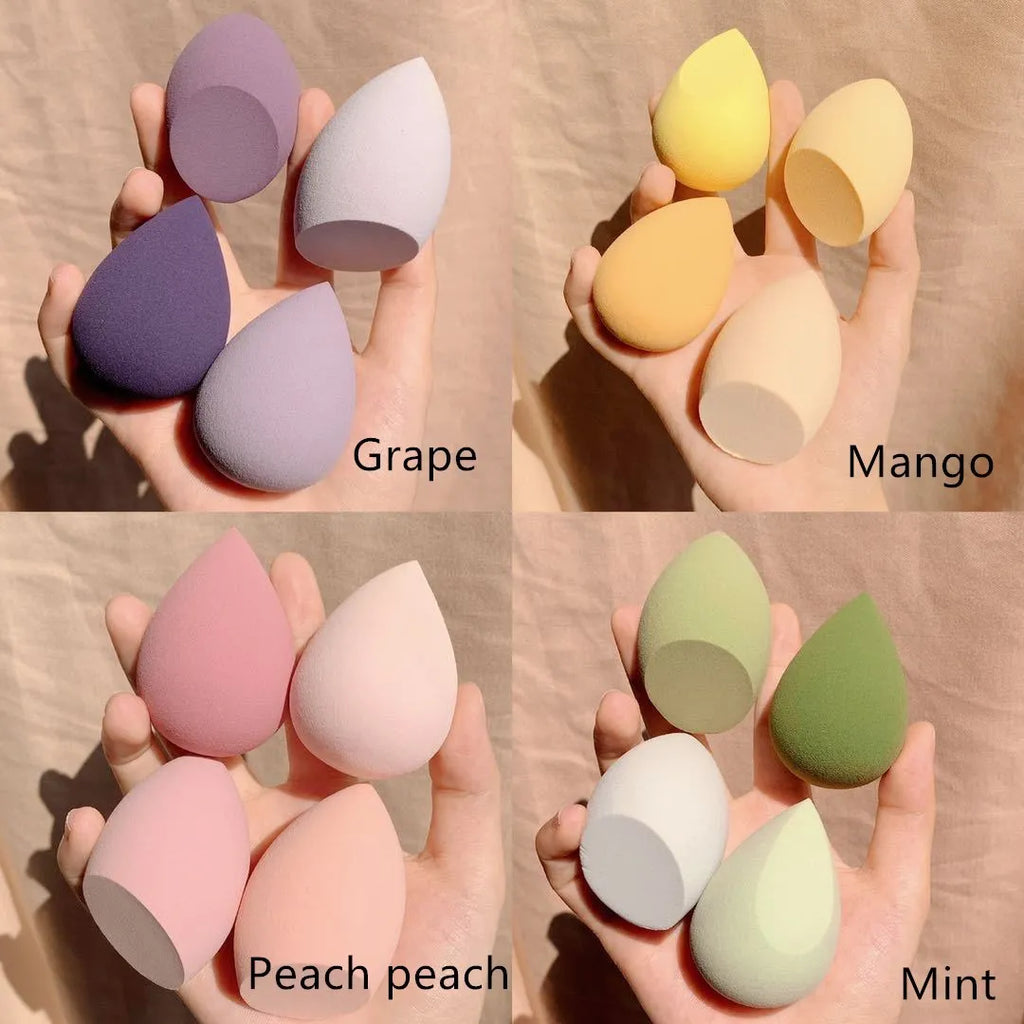 Four colourful makeup sponge eggs in grape, mango, mint and peach arranged in box