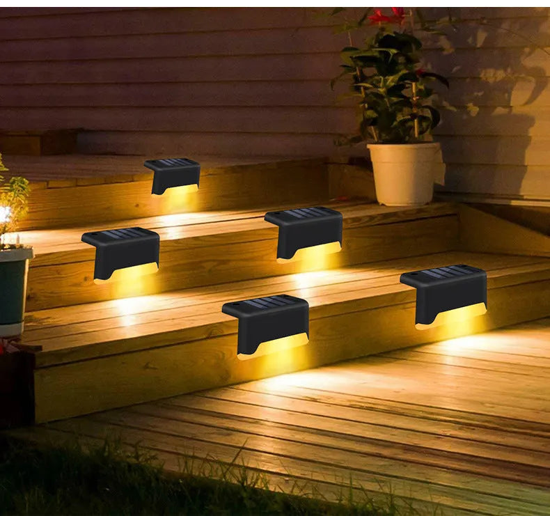 Solar garden stair light in black with warm light, compact ABS housing for outdoor courtyard use