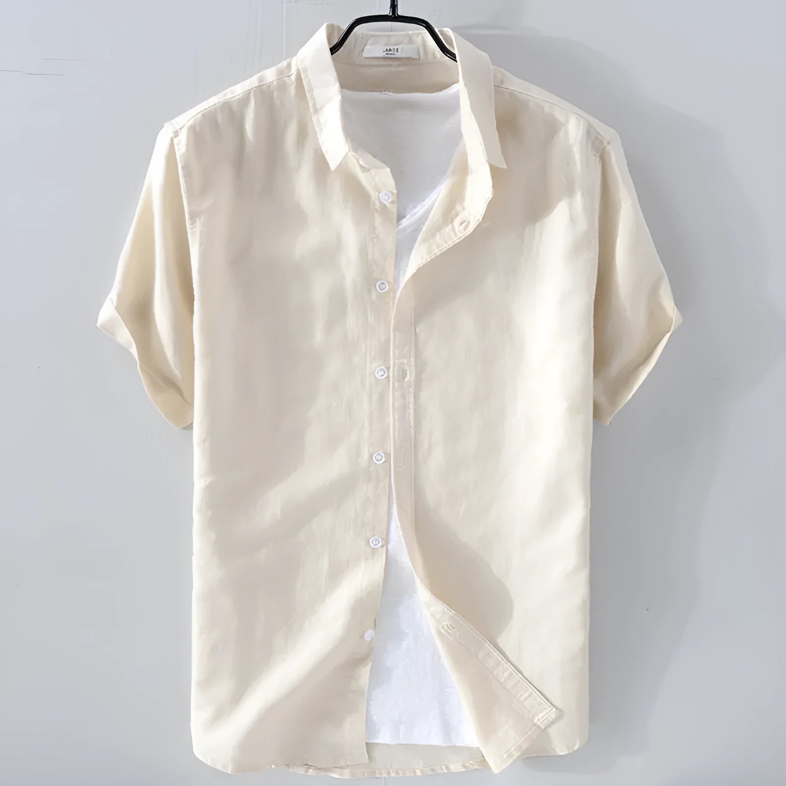 Men's loose fit short sleeve linen shirt in apricot colour on a hanger