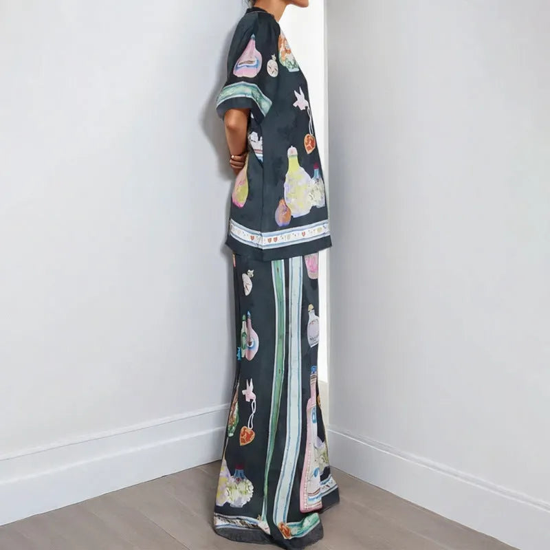 Women's black casual set with cartoon print, featuring a long-sleeve cardigan and matching trousers
