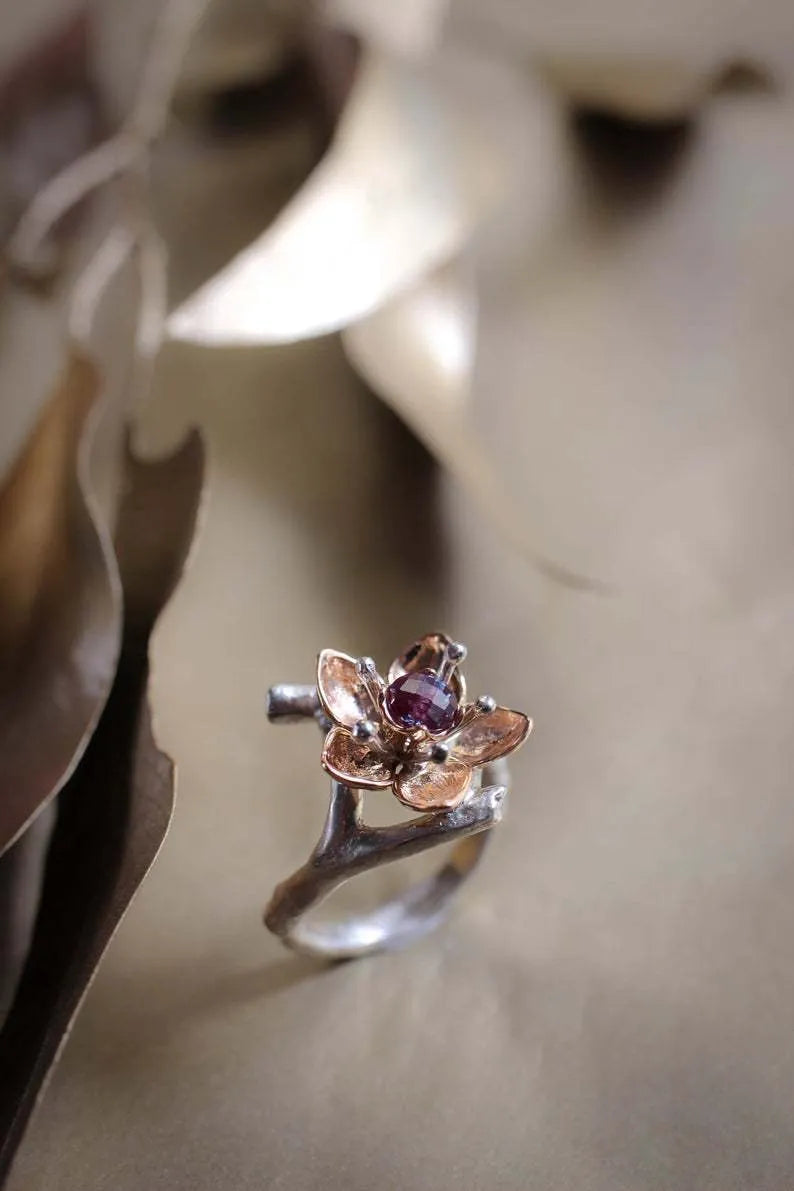 Silver two-tone geometric floral pattern women's alloy ring on a plain background.