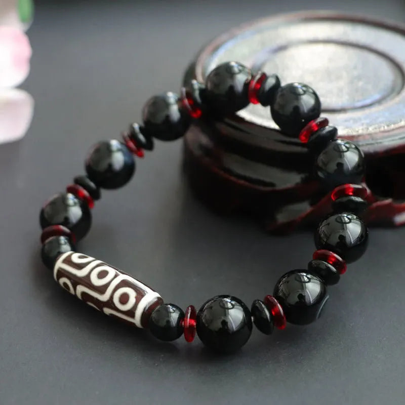 Hand-woven black agate and chalcedony dzi bead bracelet with geometric pattern