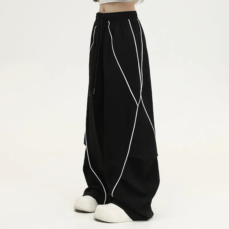 Black striped hip hop sports trousers with pleated wide-leg design on a mid waist