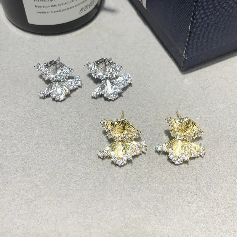 Minimalist irregular zircon stud dangle earrings in gold colour on a white background
