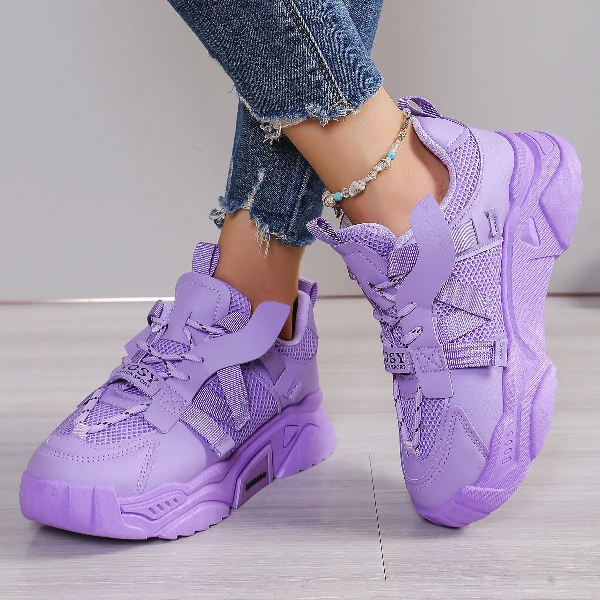 Women's purple platform mesh sports sneakers with animal pattern and lace-up front.
