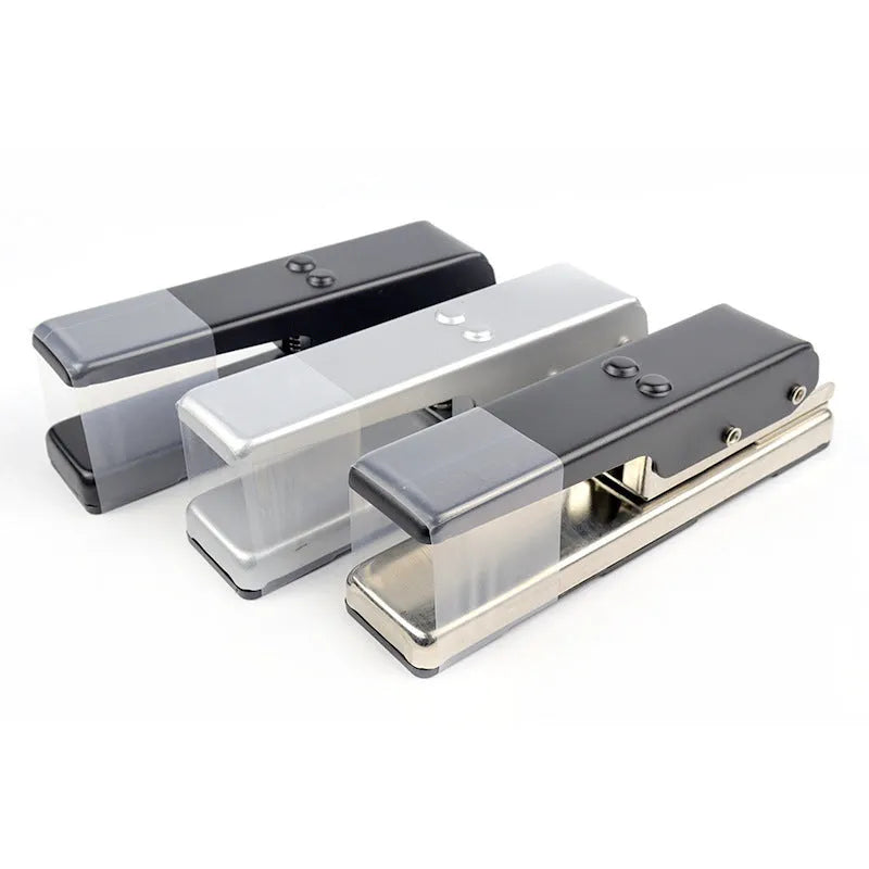 Gold metal guitar pick card cutter on a flat surface showing the punch head and metallic finish