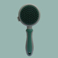 Green and pink 2-in-1 silicone cat grooming brush showing slicker brush and massage heads