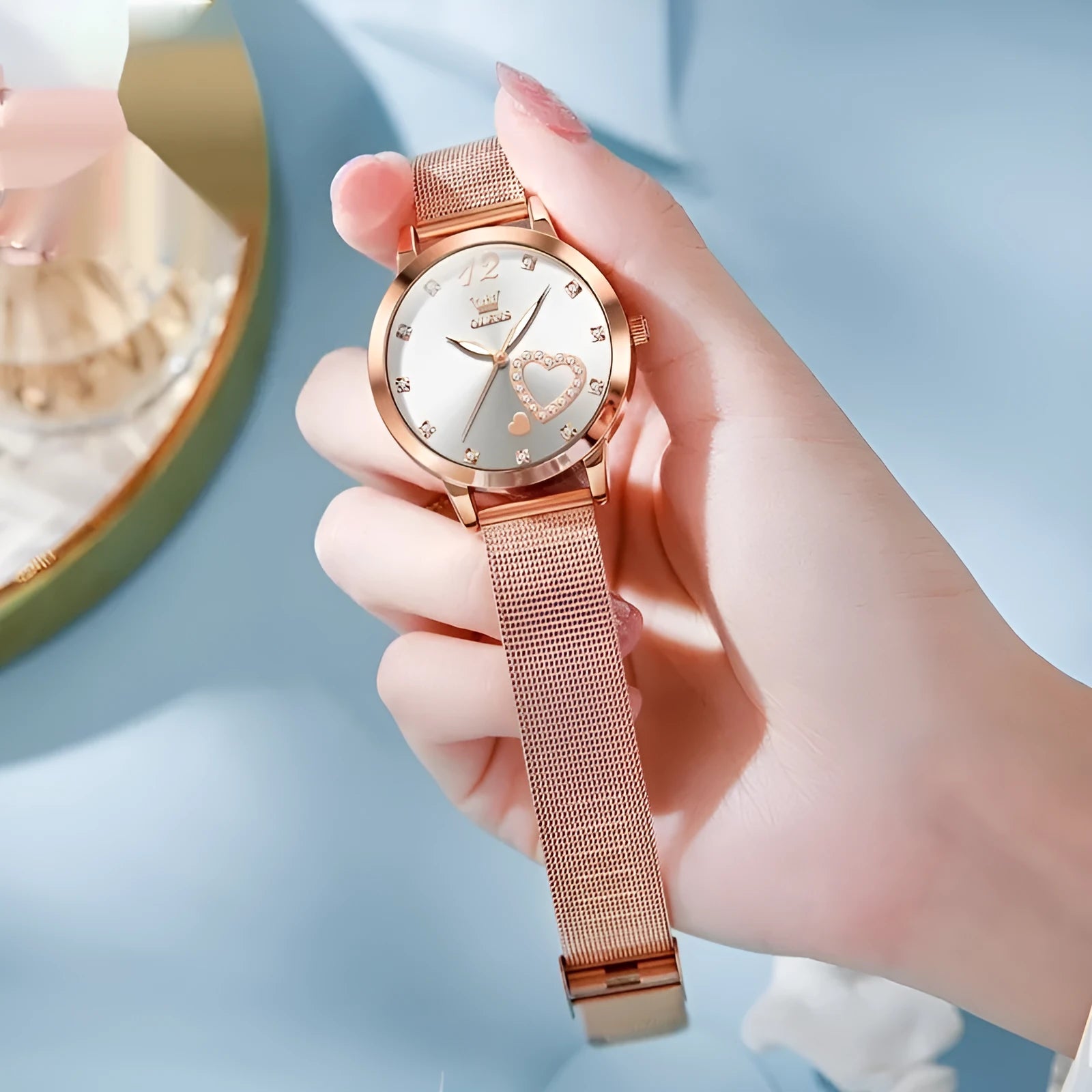 Women's rose gold fashion watch with mesh strap showing choice of six dial colours: white, black, blue, red, pink, green.