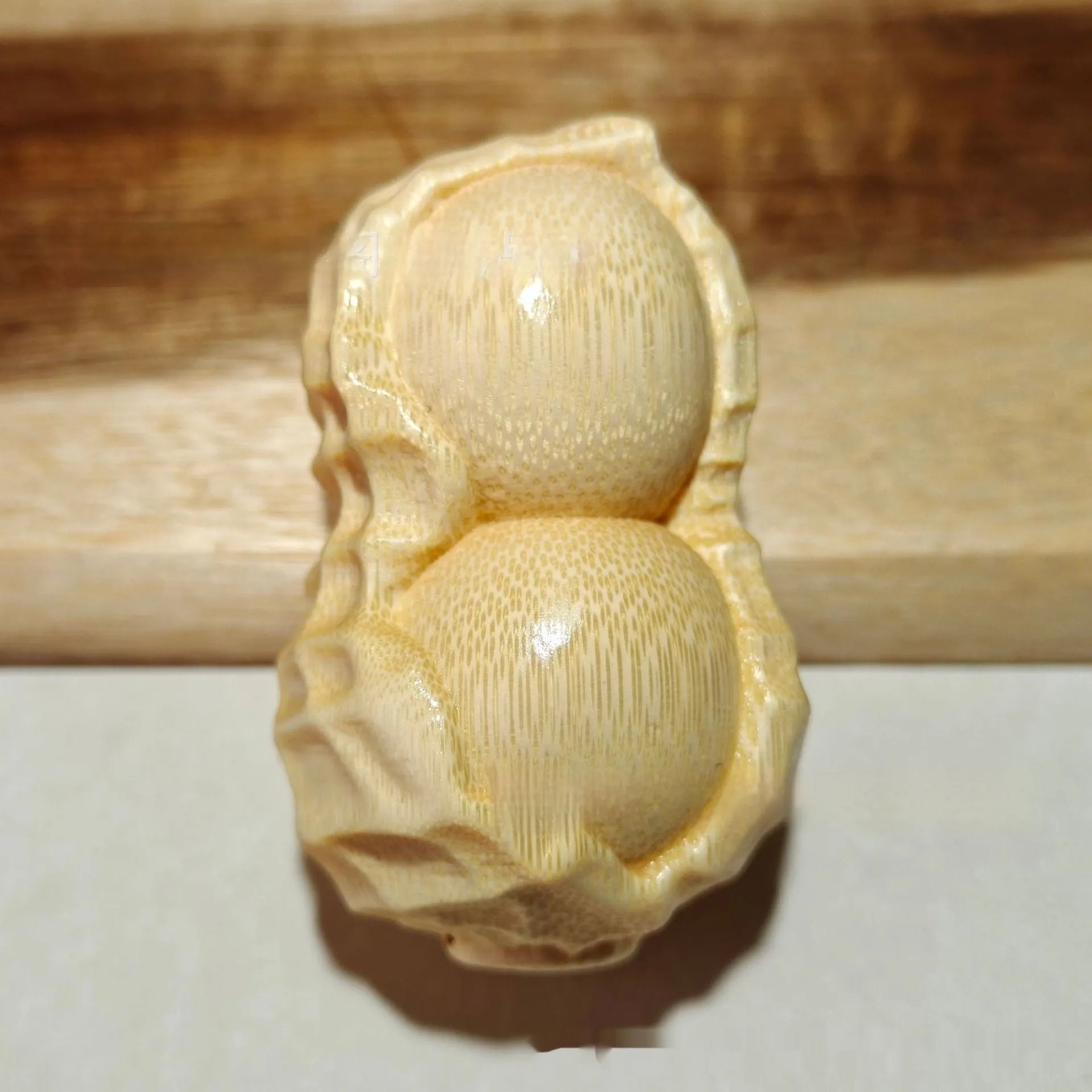 Natural bamboo carving peanut ornament with modern minimalist design and meaningful size detail