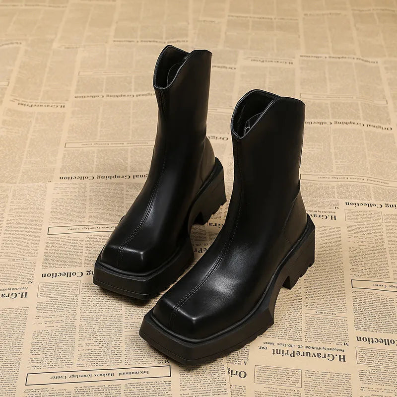 Black platform Martin boots for women with square toe, high heel, and back zip on a white background.