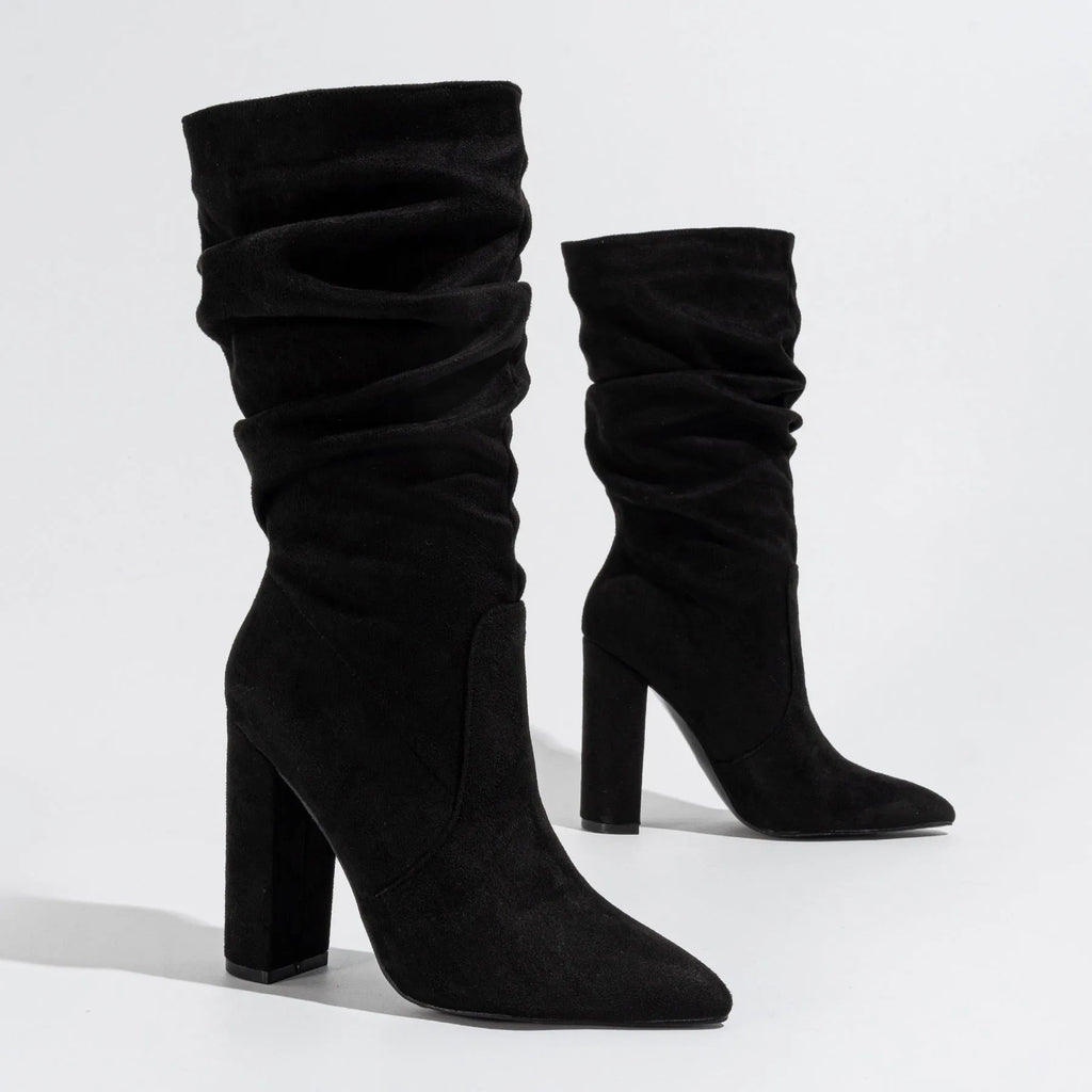 Women's black suede pointed-toe high heel boots with a chunky heel and middle calf length.