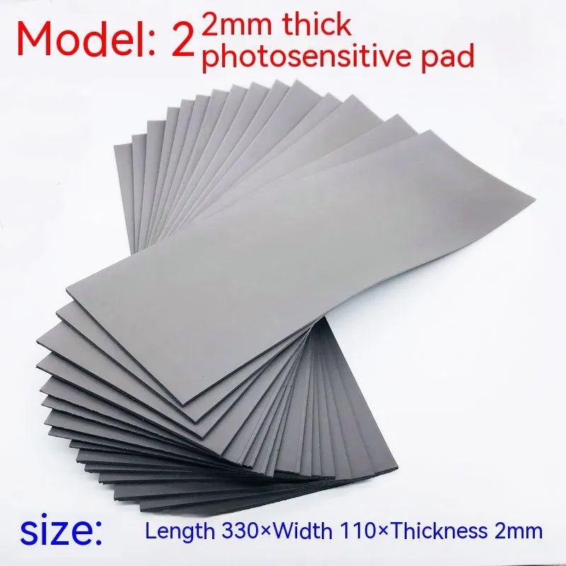 Black and grey plastic light-sensitive mat for creating seals, showing size and thickness options.