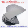 Black and grey plastic light-sensitive mat for creating seals, showing size and thickness options.