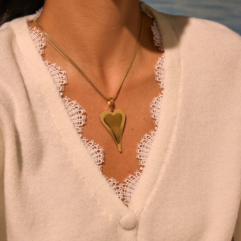 Double heart geometric pendant necklace with snake bones chain in stainless steel, shown in gold and steel colour options.