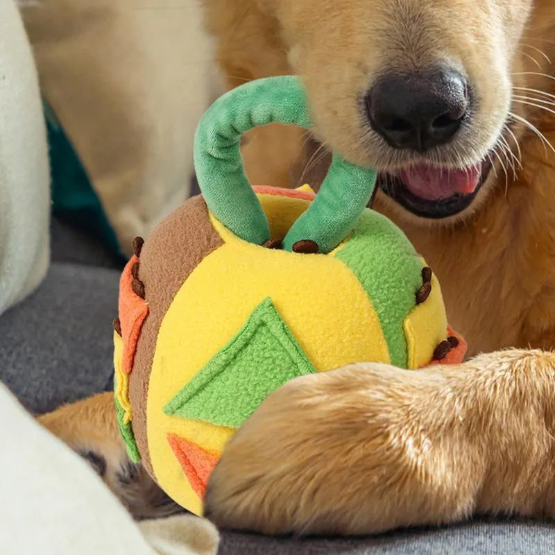 Green polyester squeaky plush ball dog toy with treat pockets on grass