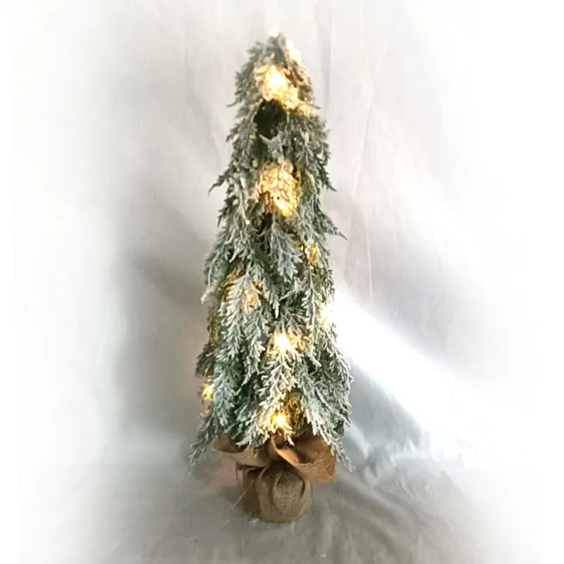 24-inch plastic Christmas tree with PE simulation snow spray effect and built-in lights on desktop