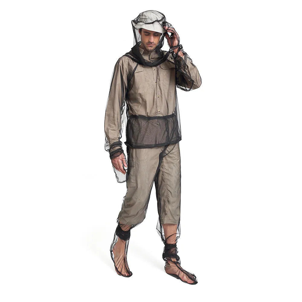 Adult wearing a full mesh anti-mosquito suit with hood, trousers, and booties for outdoor camping.