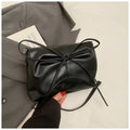 Women's black underarm crossbody bag with visible sewing lines and large capacity design