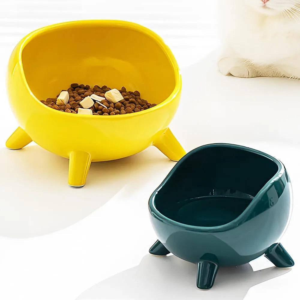 Green four-legged ceramic cat food bowl with elevated base and wide mouth design